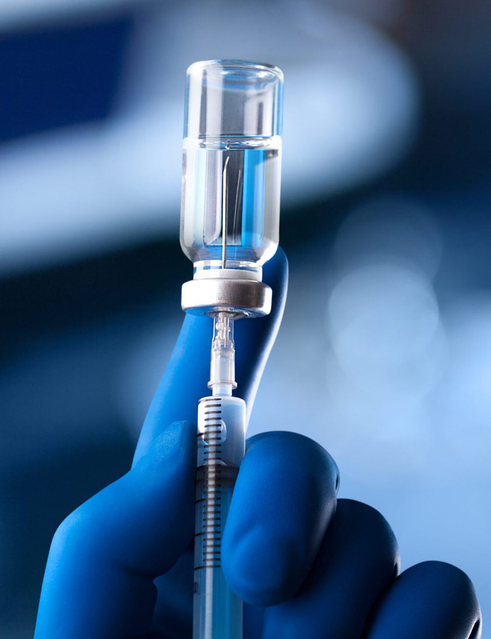 The hands in blue glove of the scientist hold the processor